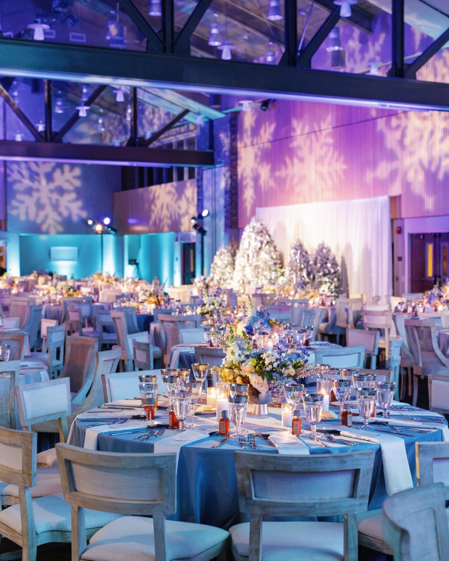 A warmly lit ballroom set for the construction industry Christmas dinner