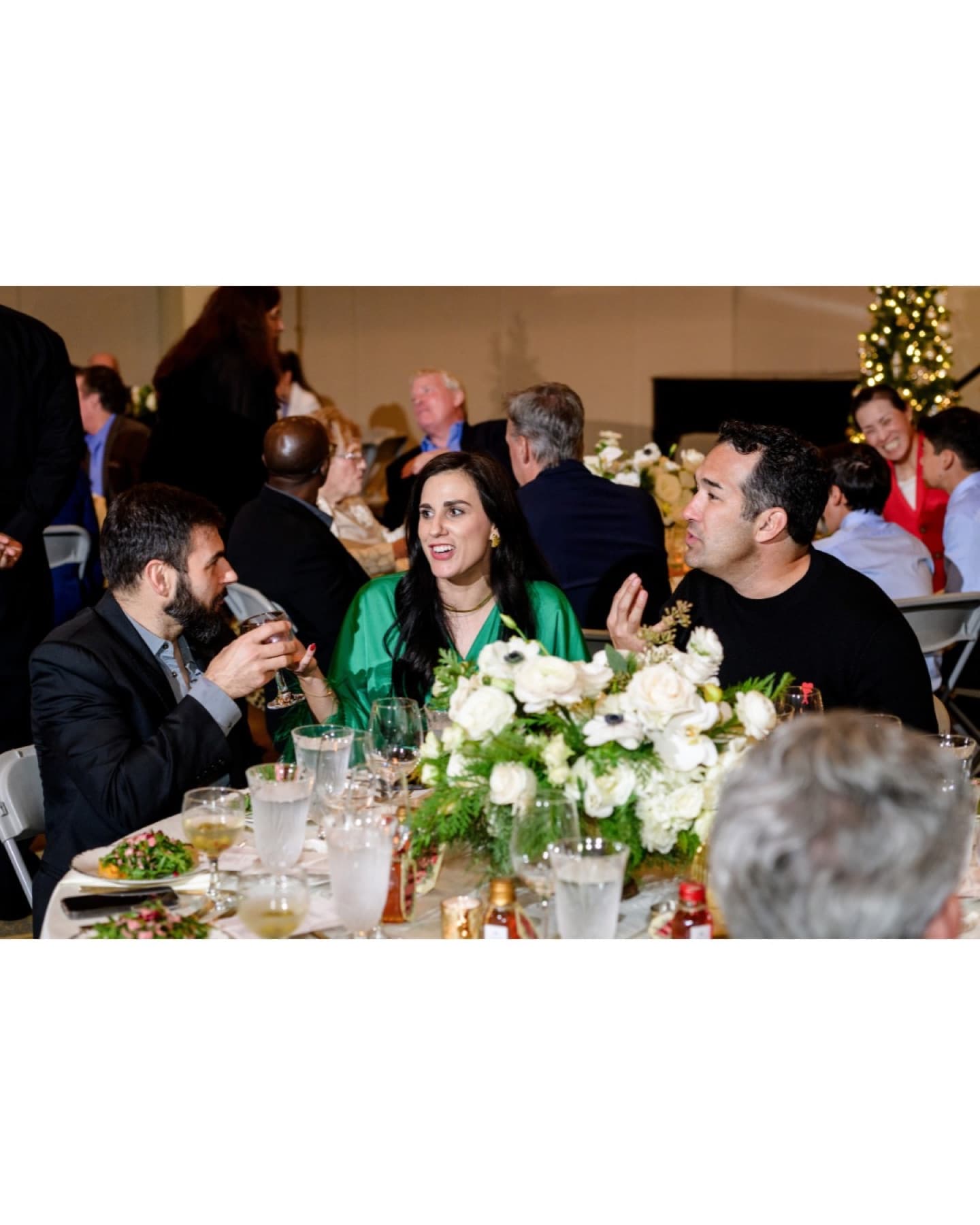 Guests gathered around a dinner table at a previous Christmas celebration